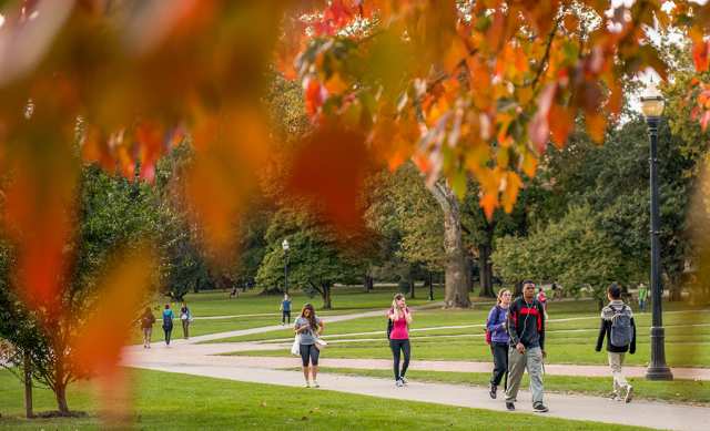 Students walking to class as trees change color on the Oval, The Ohio State University. Image courtesy of The Ohio State University