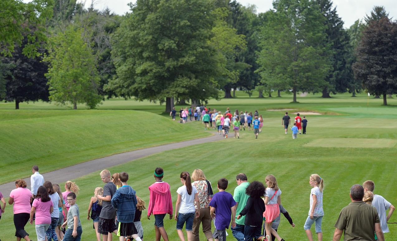 Students and members of the public walking at the Great Circle, part  of the Newark Earthworks, Heath OH. Image courtesy of Timothy E. Black.