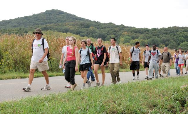 Ohio State students participating in the Earthworks Pilgrimage as part of the Newark Earthwork's Center's Walk with the Ancients resume their walk after a visit to Great Seal State Park north of Chillicothe, Ohio, Saturday, Sept. 11, 2010. In the background is the peak of Sugarloaf Mountain. Image courtesy by Timothy E. Black.