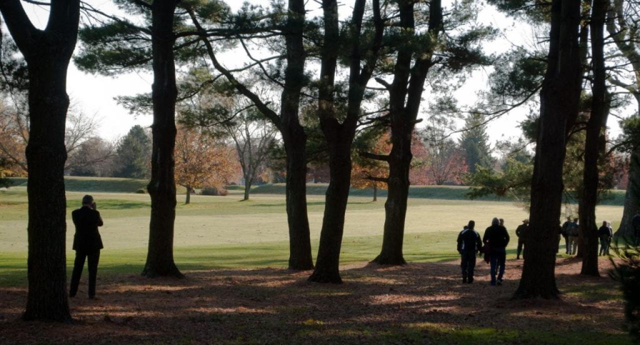 View of the Octagon State Memorial behind trees with people walking away in the foreground. Image courtesy of Timothy E. Black