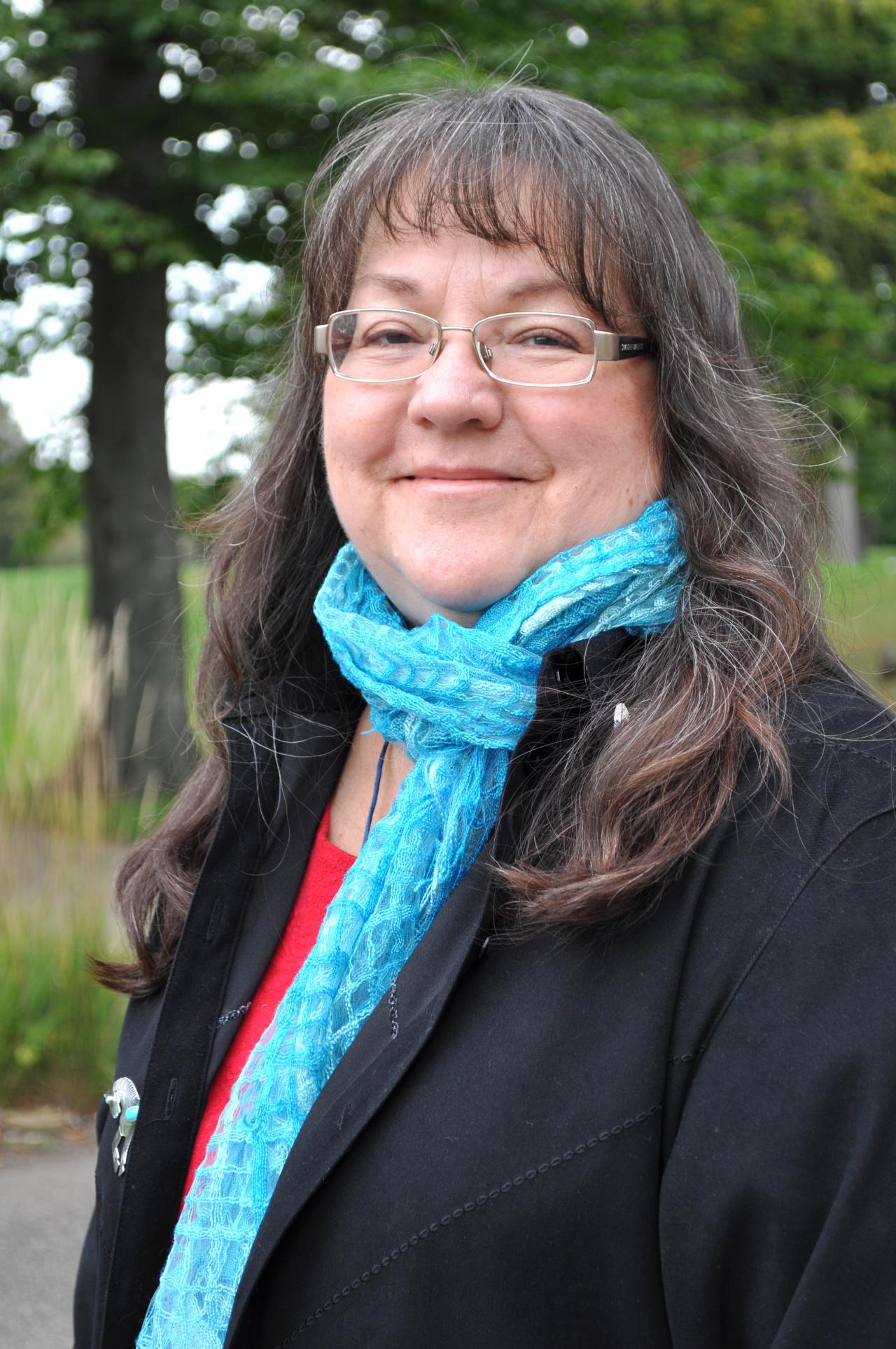 Marti Chaatsmith wearing a blue scarf. Image courtesy of Marti Chaatsmith.