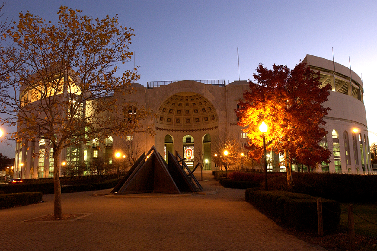 Outside the Shoe Ohio Stadium at dusk with streetlights lit with no pedestrians. Image courtesy of The Ohio State University.