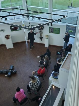 Artist Gerry Lang (Chowanoke Nation) at the LeFevre Art Gallery describing his Return from Exile exhibition