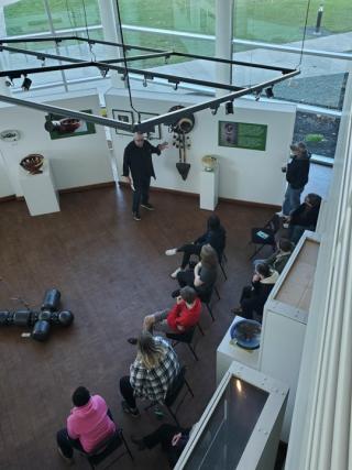 Artist Gerry Lang (Chowanoke Nation) at the LeFevre Art Gallery describing his Return from Exile exhibition 