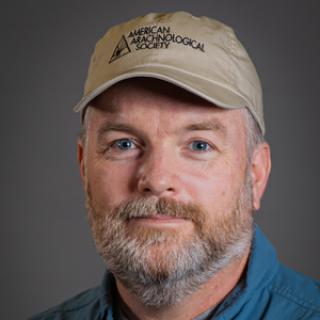 Dr. J. Andrew Roberts in a blue collared shirt and tan baseball cap from the American Arachnological Society. Image courtesy of The Ohio State University.