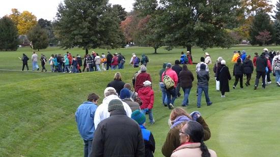 People carefully walking in a procession into the Octagon State Memorial. Image courtesy of Timothy E. Black.