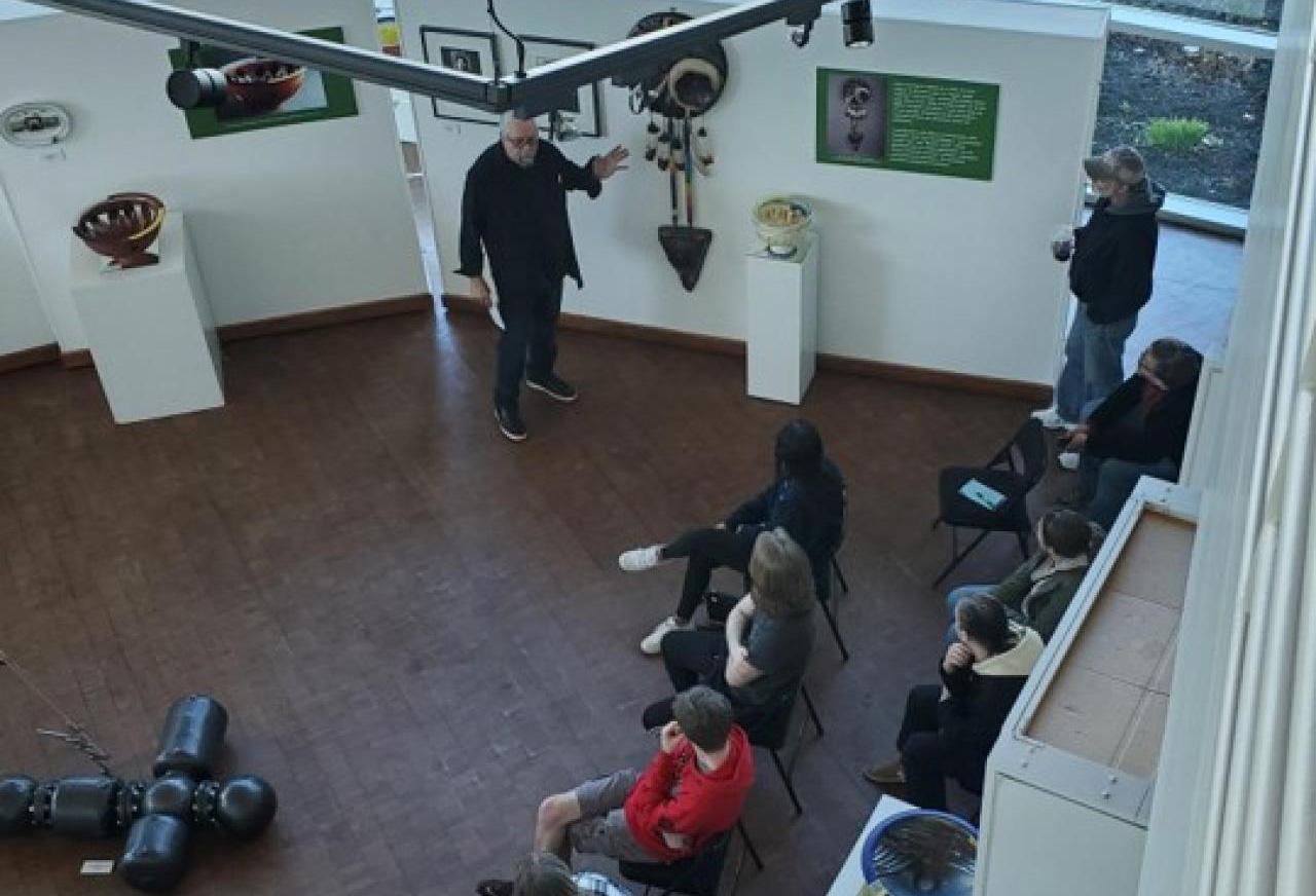 Artist Gerry Lang (Chowanoke Nation) at the LeFevre Art Gallery describing his exhibition