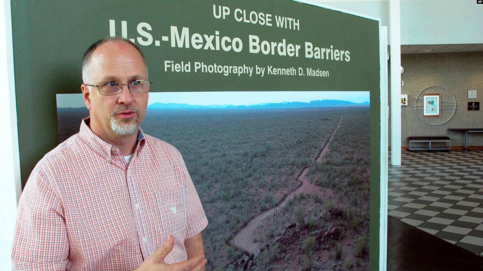 Professor Kenneth Madsen speaking in front of border sign