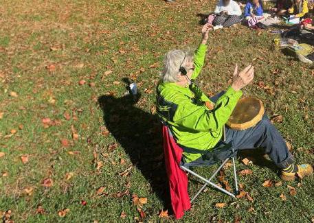 Man in camp chair with fall leaves